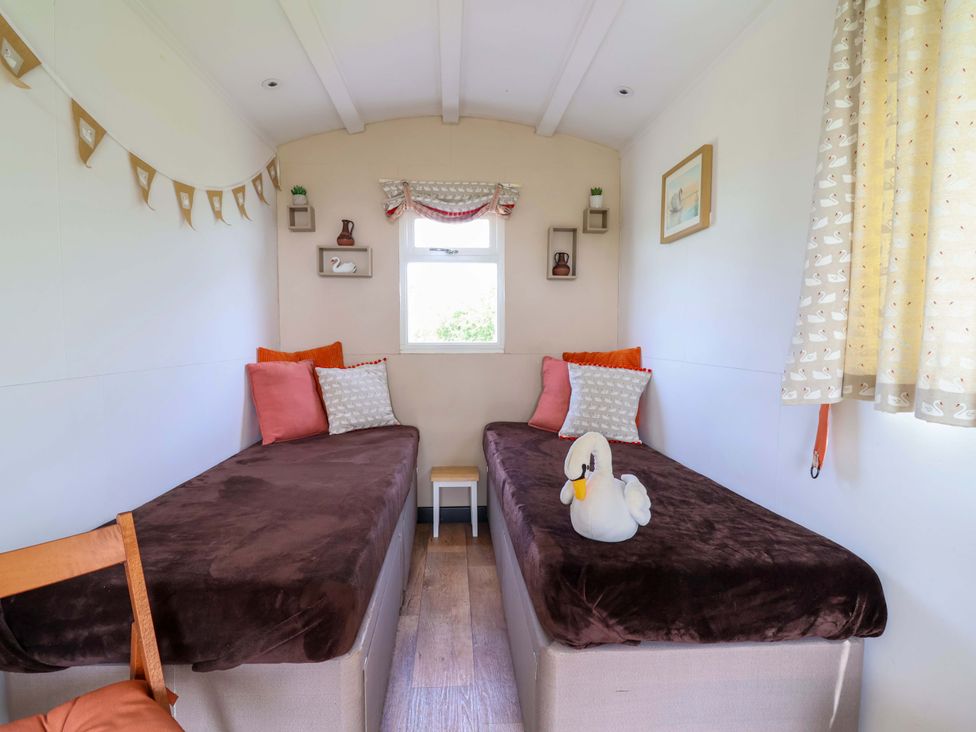 A bedroom with two beds and a window at Sid's Nest