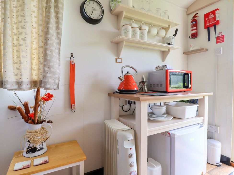 A kitchen with appliances and utensils at Sid's Nest