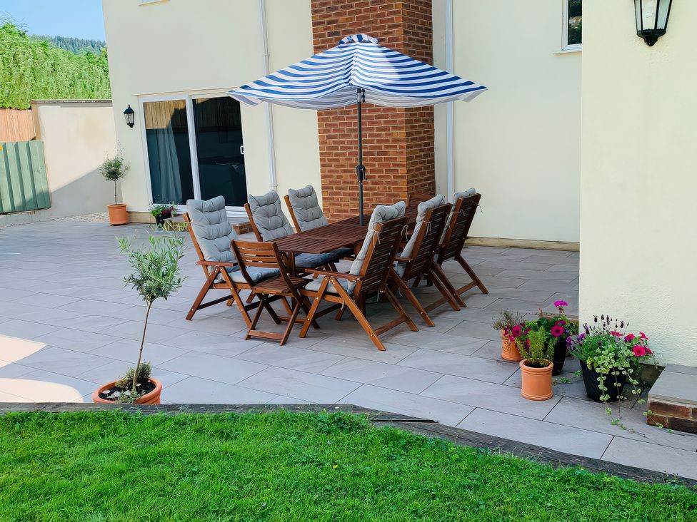 An outdoor dining area with table and chairs at Brooklands in Uplyme
