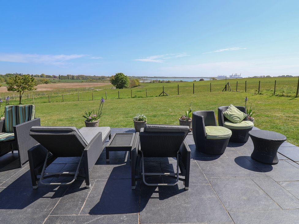 An outdoor seating area with chairs and a table at Polly's Annexe in Levington