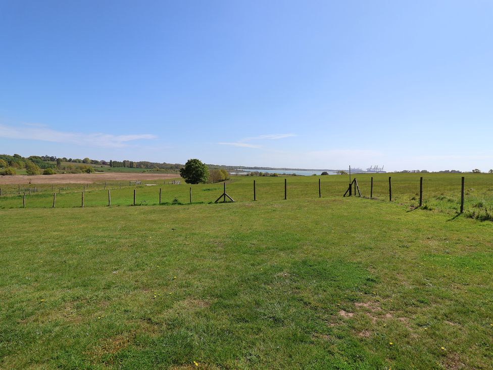 A field with a fence and tree at Polly's Annexe Levington