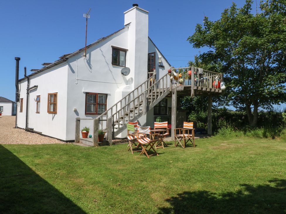 An outdoor area with chairs and stairs at Borth Arian Boat House in Holyhead