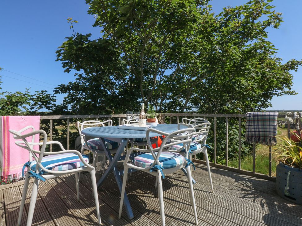 An outdoor space with a table and chairs at Borth Arian Boat House Holyhead