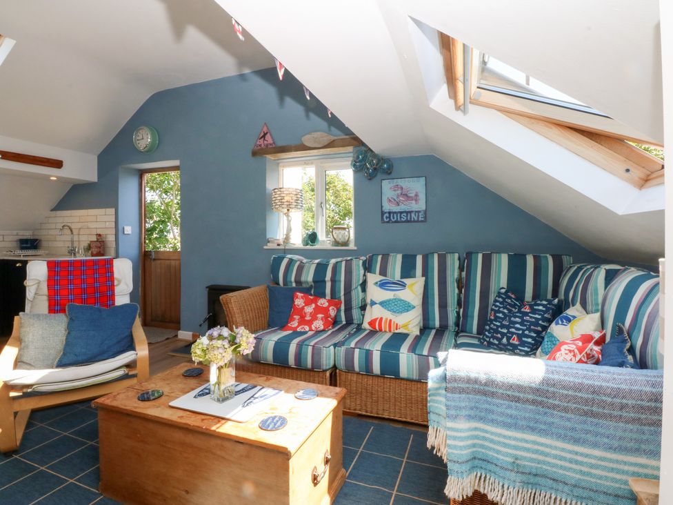A living room with a sofa and coffee table at Borth Arian Boat House in Holyhead