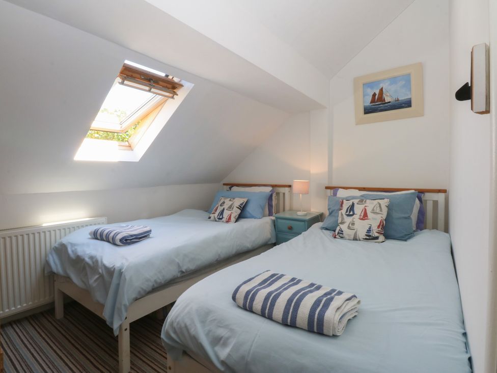 A bedroom with two beds and a window at Borth Arian Boat House Holyhead