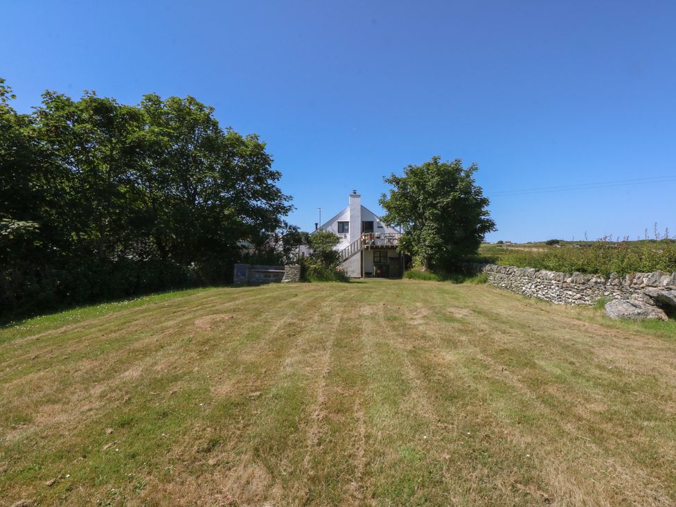 A house with a garden and trees at Borth Arian Boat House in Holyhead