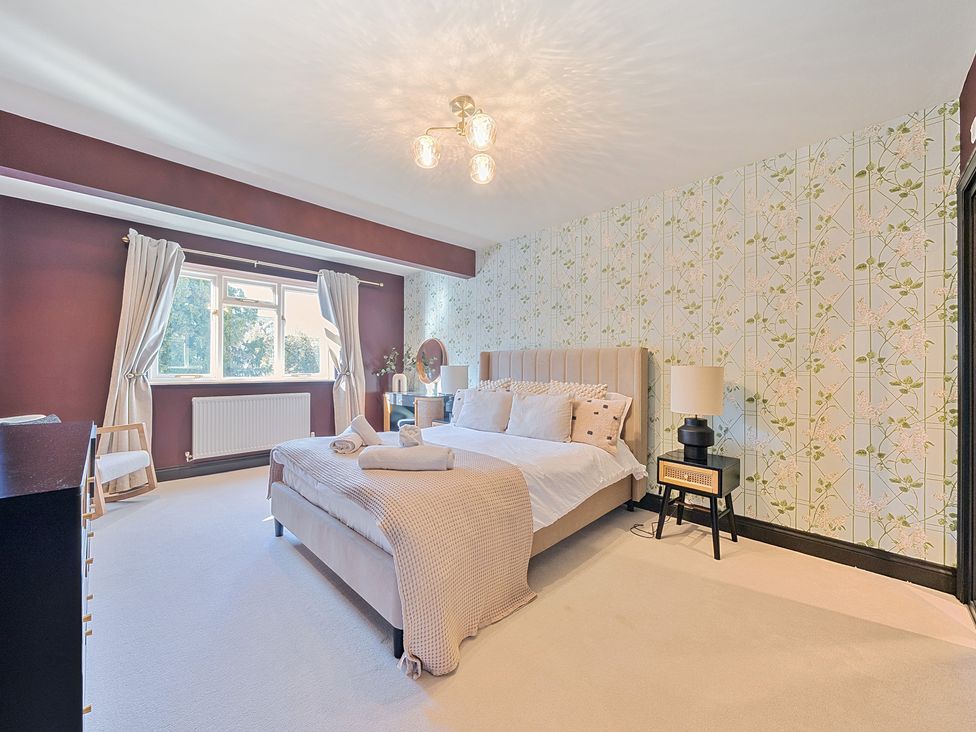 A bedroom with a bed and bedside table at 8 Newmarket Road Royston