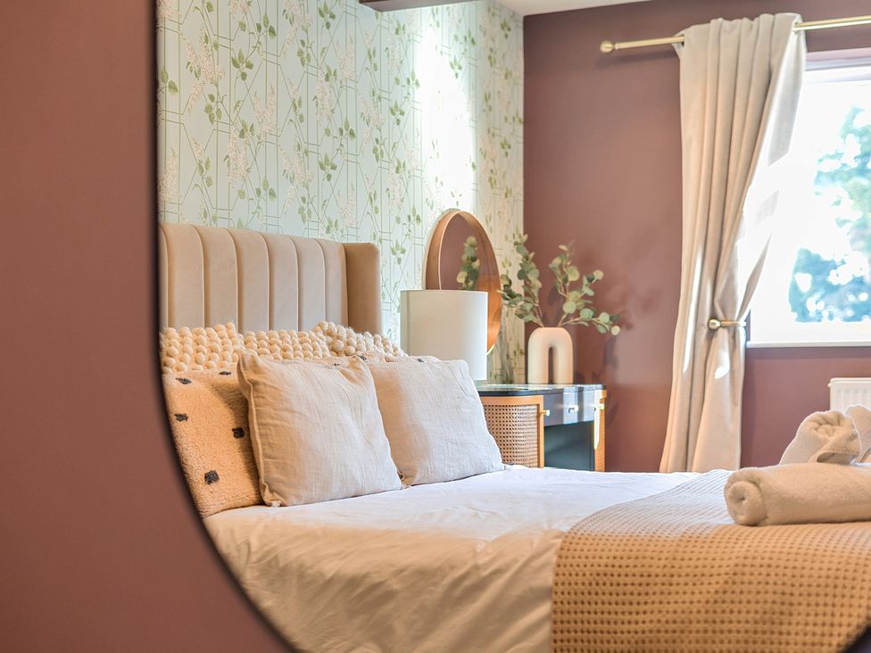 A bedroom with a bed and lamp at 8 Newmarket Road Royston