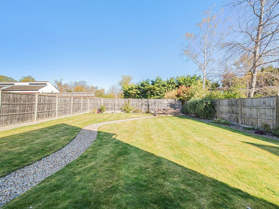 A garden with a path and furniture at 8 Newmarket Road Royston