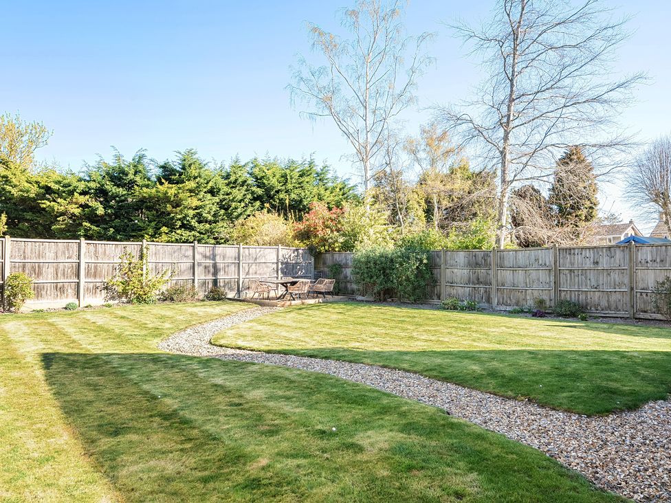 A garden with a path and seating area at 8 Newmarket Road in Royston