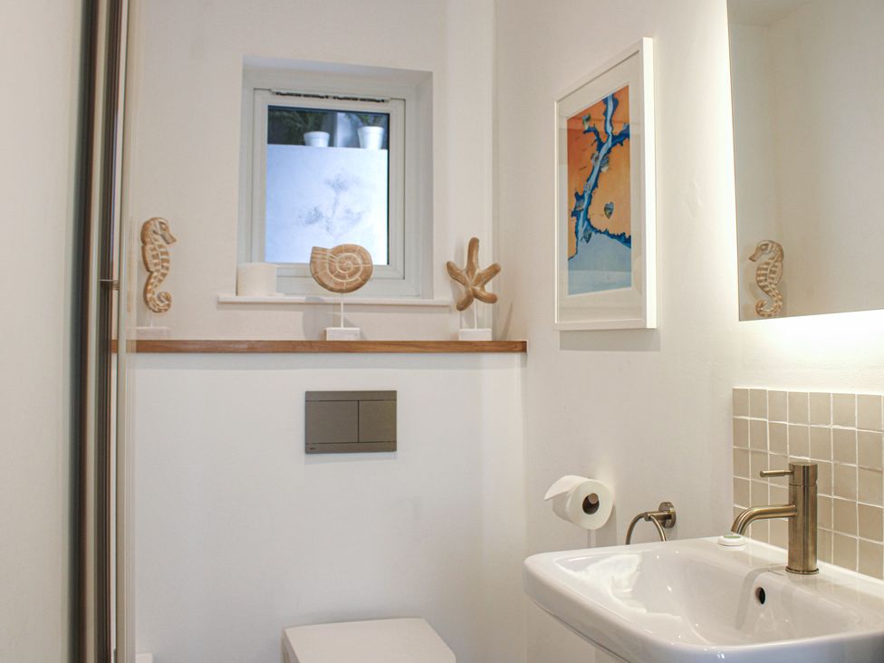 A bathroom with a sink and a toilet at 2 Channel View in Salcombe