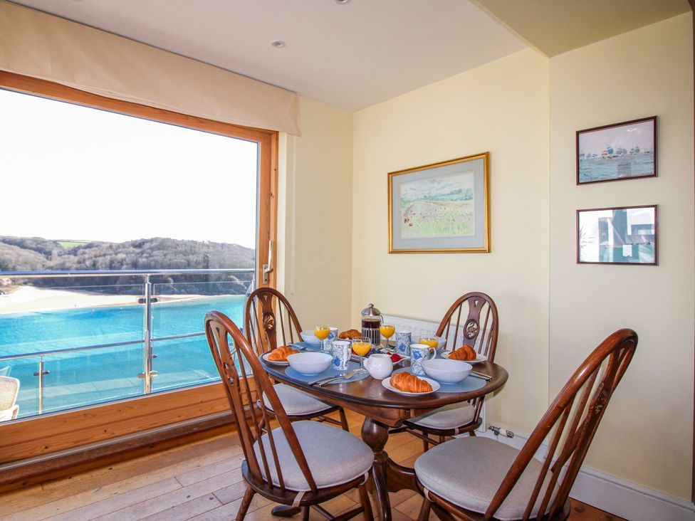 A dining room with a table set for breakfast at 2 Channel View in Salcombe