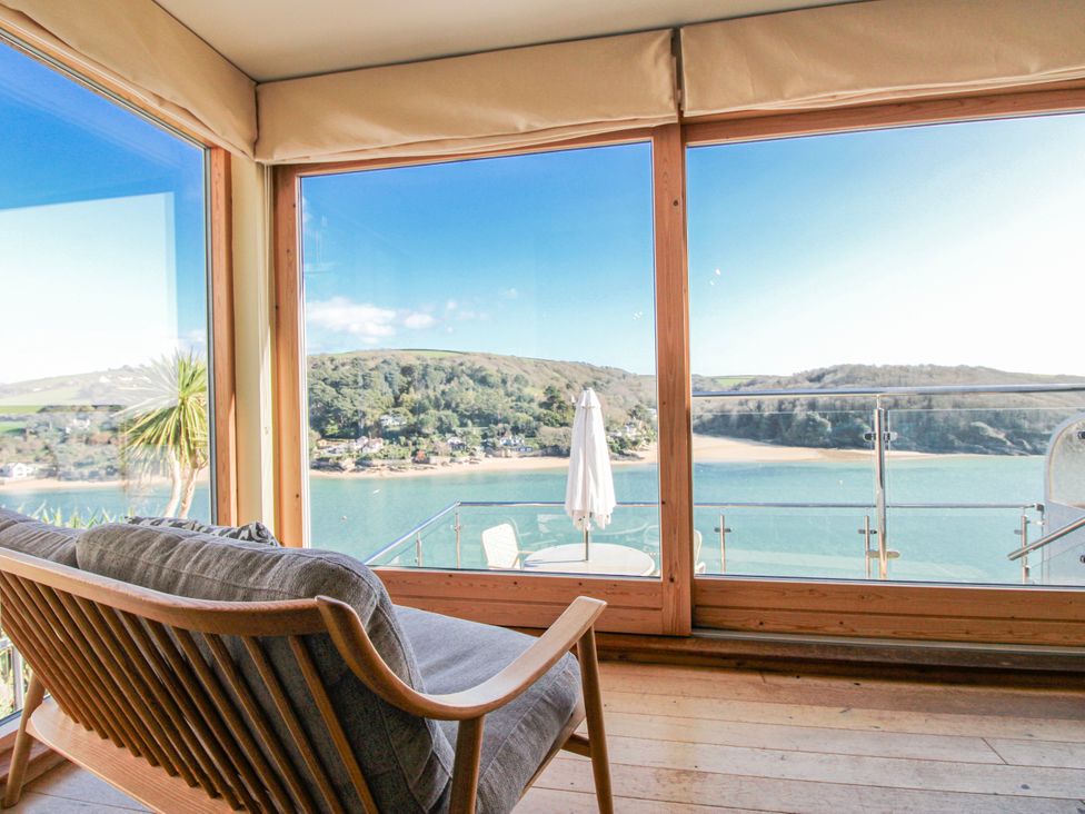 A living room with a view of hills and bay at 2 Channel View Salcombe