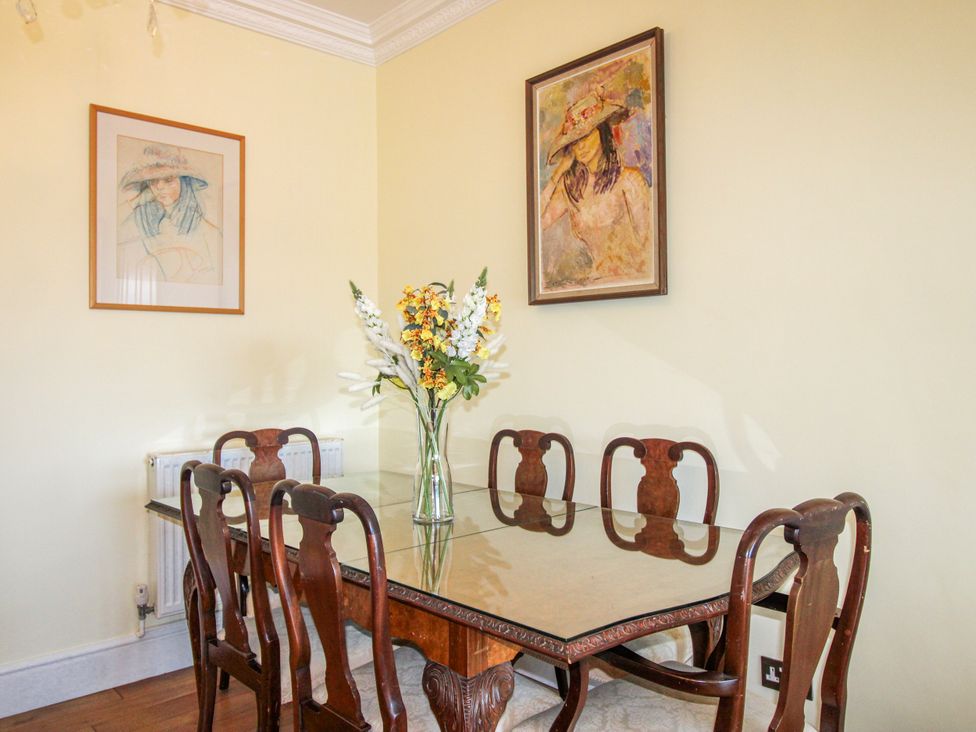 A dining room with a table and chairs at 2 Channel View Salcombe