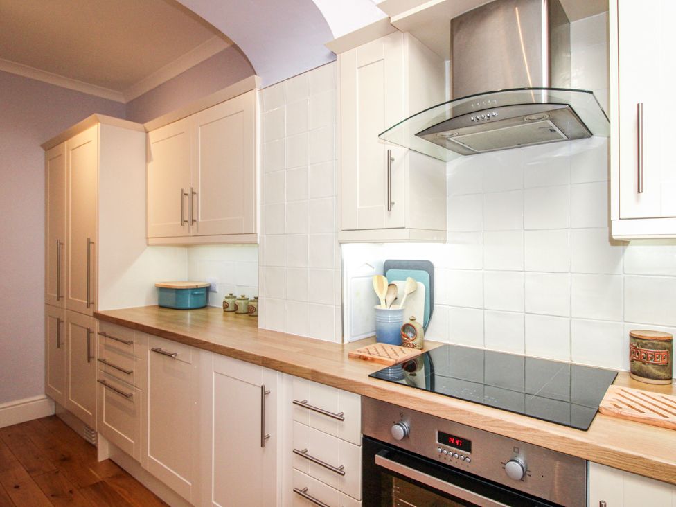 A kitchen with cabinets and cooktop at 2 Channel View in Salcombe