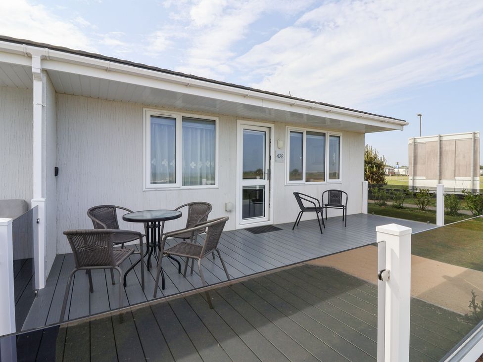 An outdoor patio with a table and chairs at Bonny Bay in Wilsthorpe near Bridlington