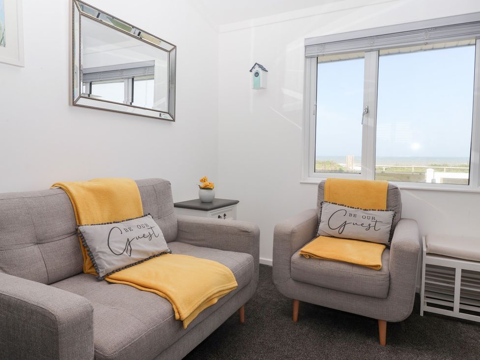 A living room with a sofa and armchair at Bonny Bay in Wilsthorpe near Bridlington