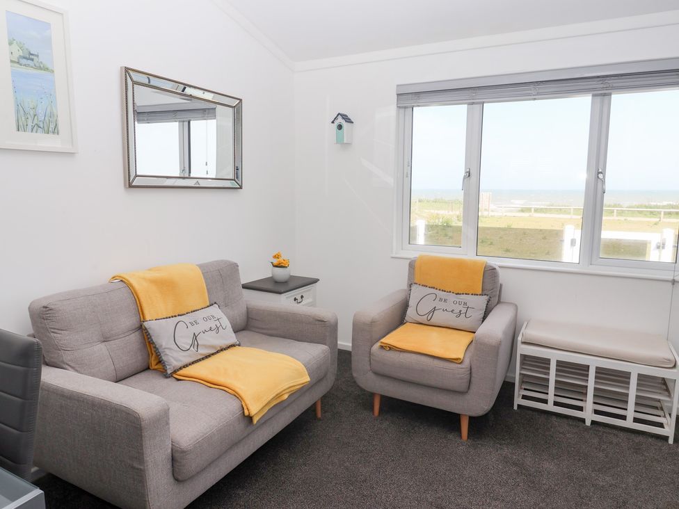 A living room with two sofas and a view of the outside at Bonny Bay in Wilsthorpe near Bridlington