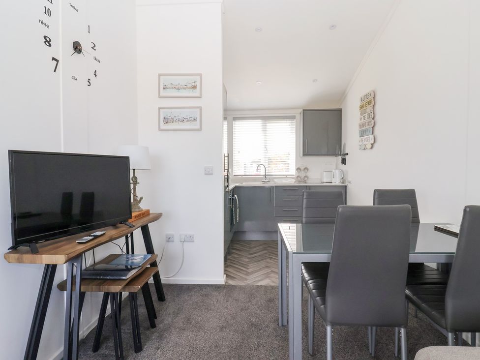 A dining area with a table and chairs at Bonny Bay in Wilsthorpe near Bridlington