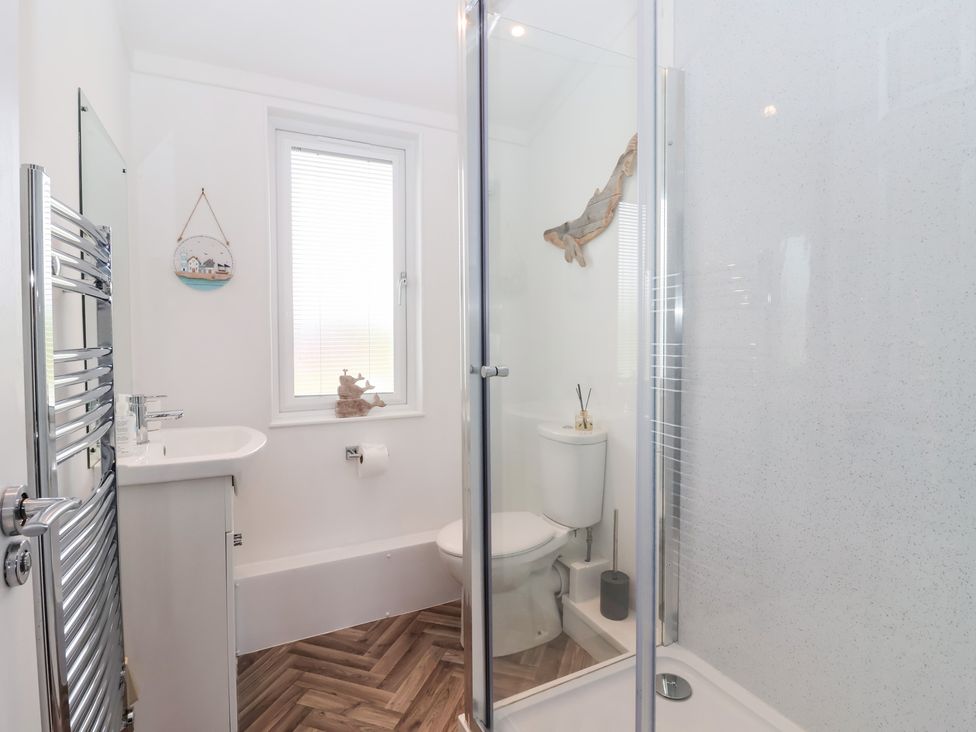 A bathroom with a shower, toilet, and sink at Bonny Bay in Wilsthorpe near Bridlington