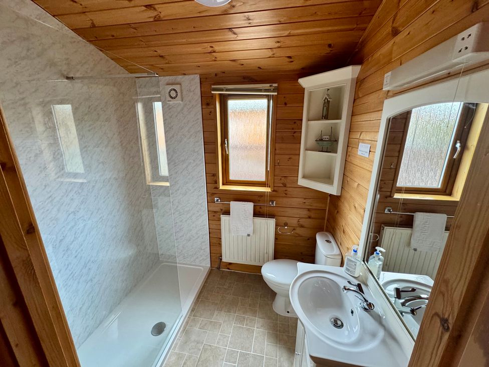 A bathroom with a shower, toilet, and sink at Sea Breeze in Ilfracombe