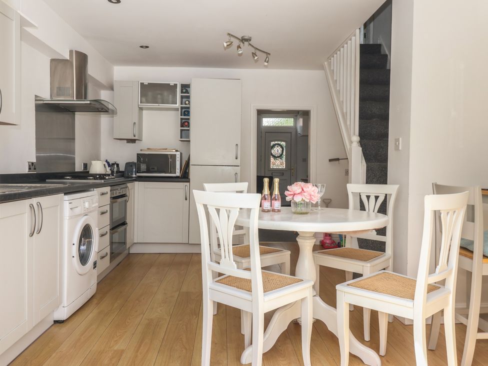 A kitchen with a table and chairs at Bluebell Cottage in Brayton