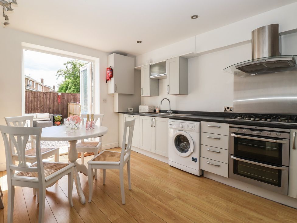A kitchen with a table and chairs at Bluebell Cottage in Brayton