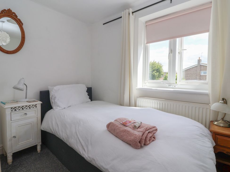 A bedroom with a bed and bedside tables at Bluebell Cottage Brayton