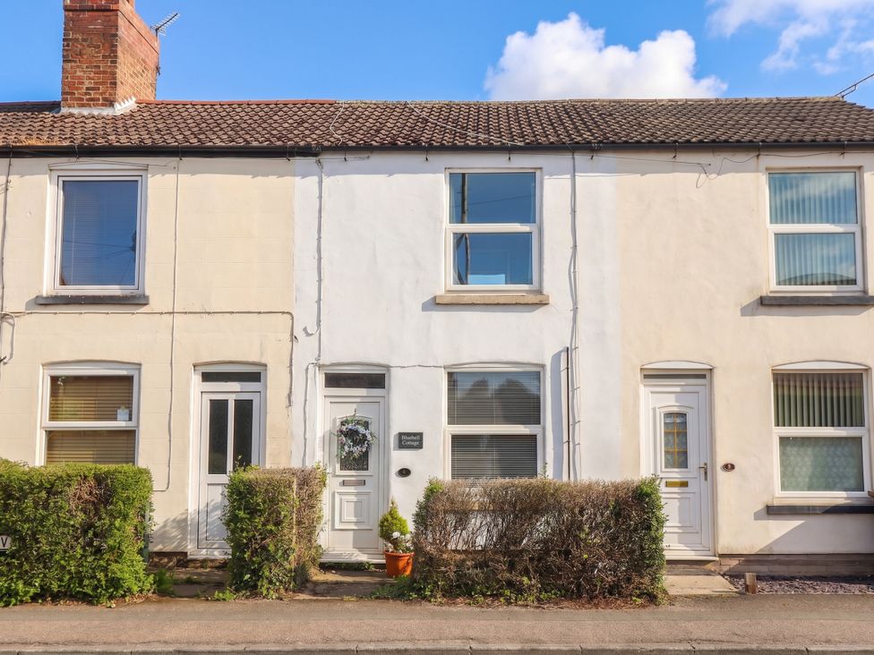 A building facade with front doors and windows at Bluebell Cottage in Brayton