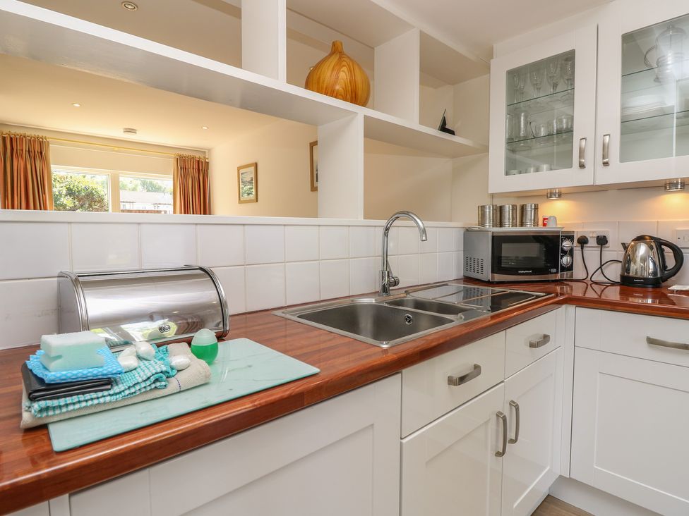 A kitchen with a sink and microwave at Delaware M2 in Yarmouth