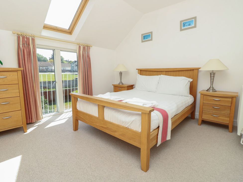 A bedroom with a bed and nightstands at Delaware M2 in Yarmouth