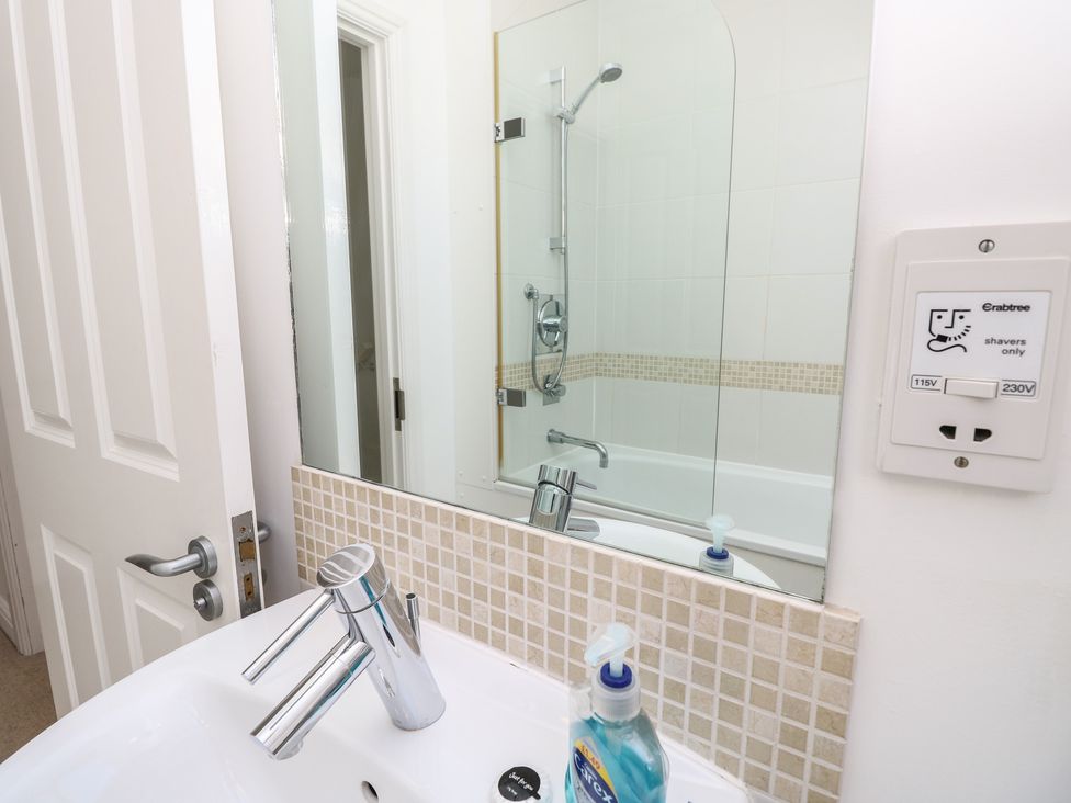 A bathroom with a sink and mirror at Delaware M2 in Yarmouth
