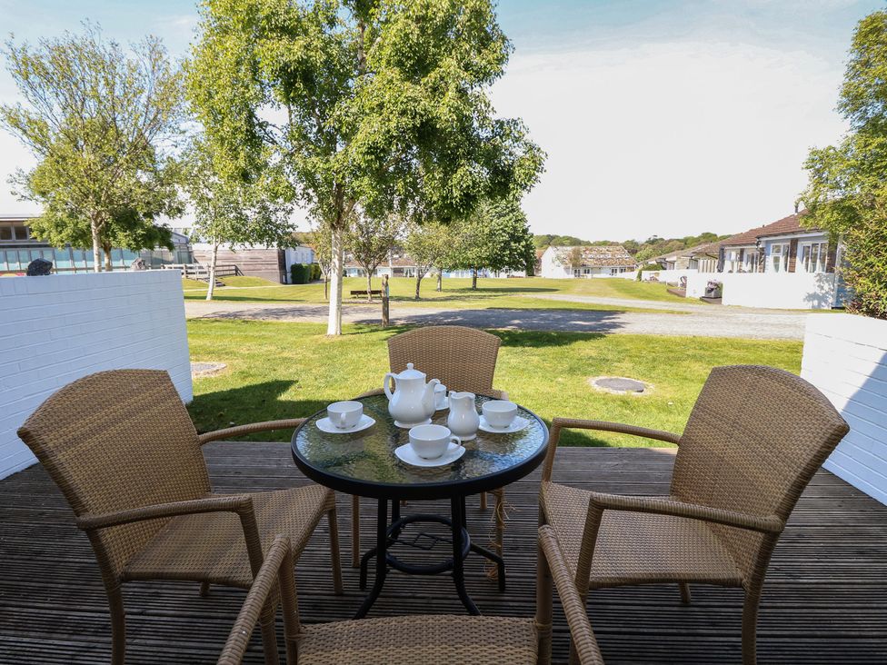 An outdoor seating area with a table and teapot at Delaware M2 in Yarmouth