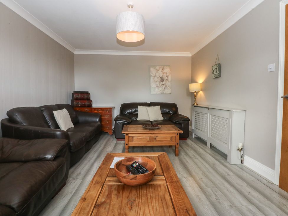 A living room with sofas and a coffee table at 2 Trem Y Don in Colwyn Bay