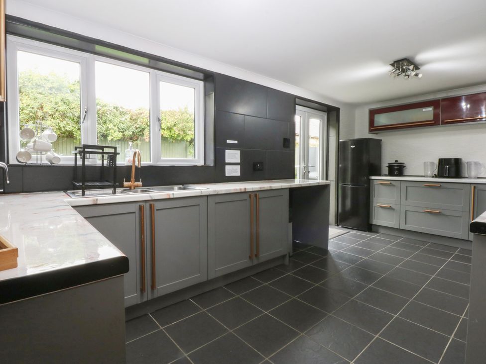 A kitchen with a sink and cabinets at 2 Trem Y Don in Colwyn Bay