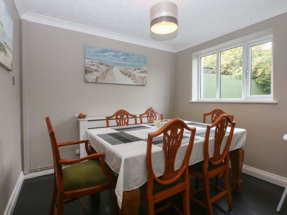 A dining room with a table and chairs at 2 Trem Y Don in Colwyn Bay