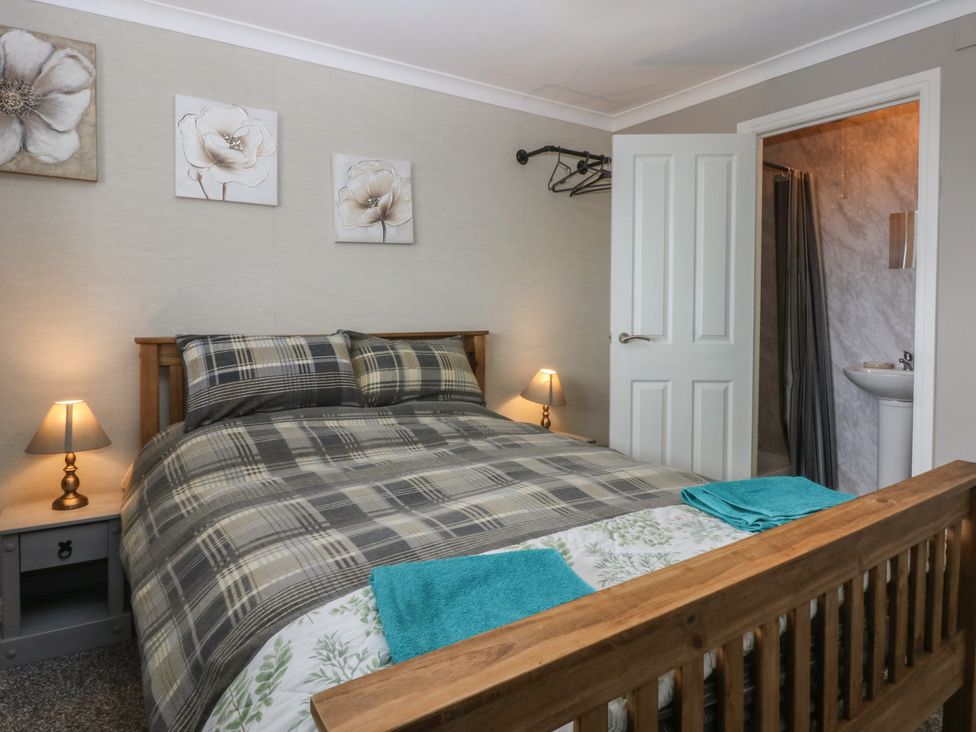 A bedroom with a bed and attached bathroom at 2 Trem Y Don, Colwyn Bay