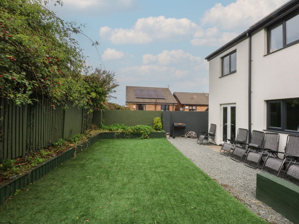 A garden with chairs and a barbecue at 2 Trem Y Don in Colwyn Bay
