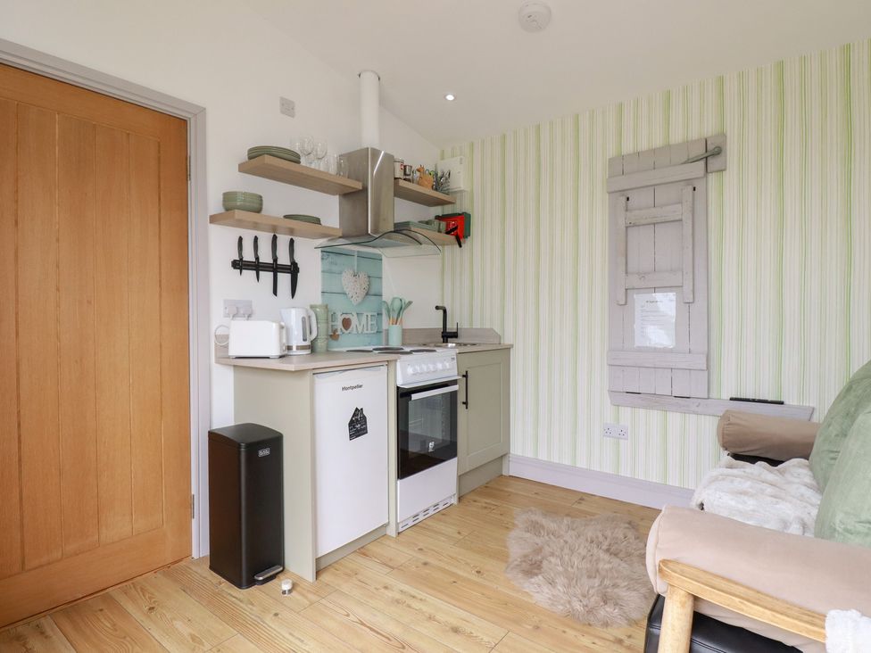 A kitchen with a sink and stove at The Tinystore in Bodmin