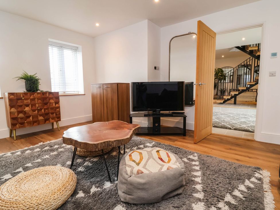 A living room with a television and coffee table at The Granary in Barnstaple