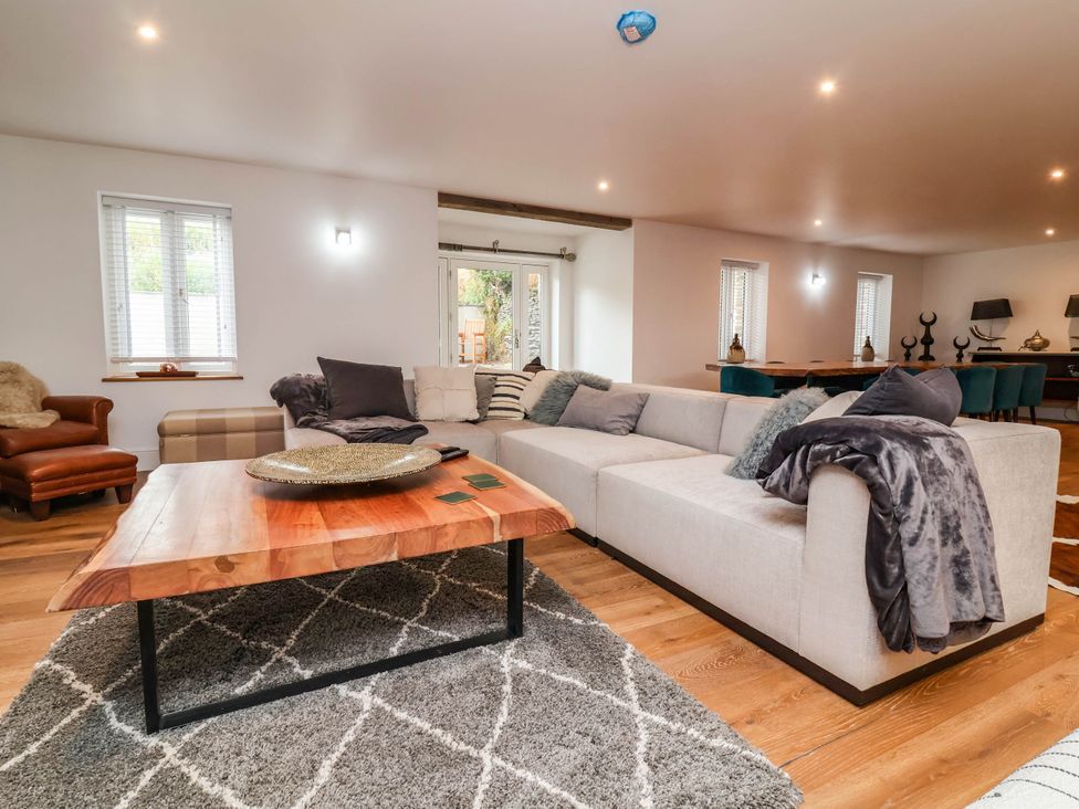A living room with a sofa, coffee table and armchair at The Granary in Barnstaple