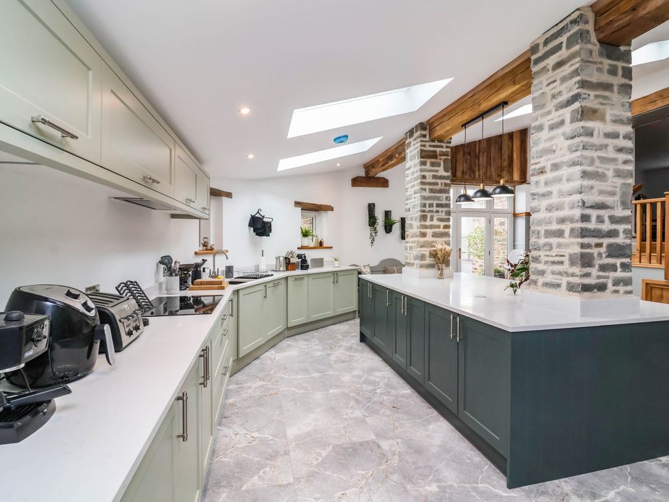 A kitchen with an island counter and appliances at The Granary in Barnstaple