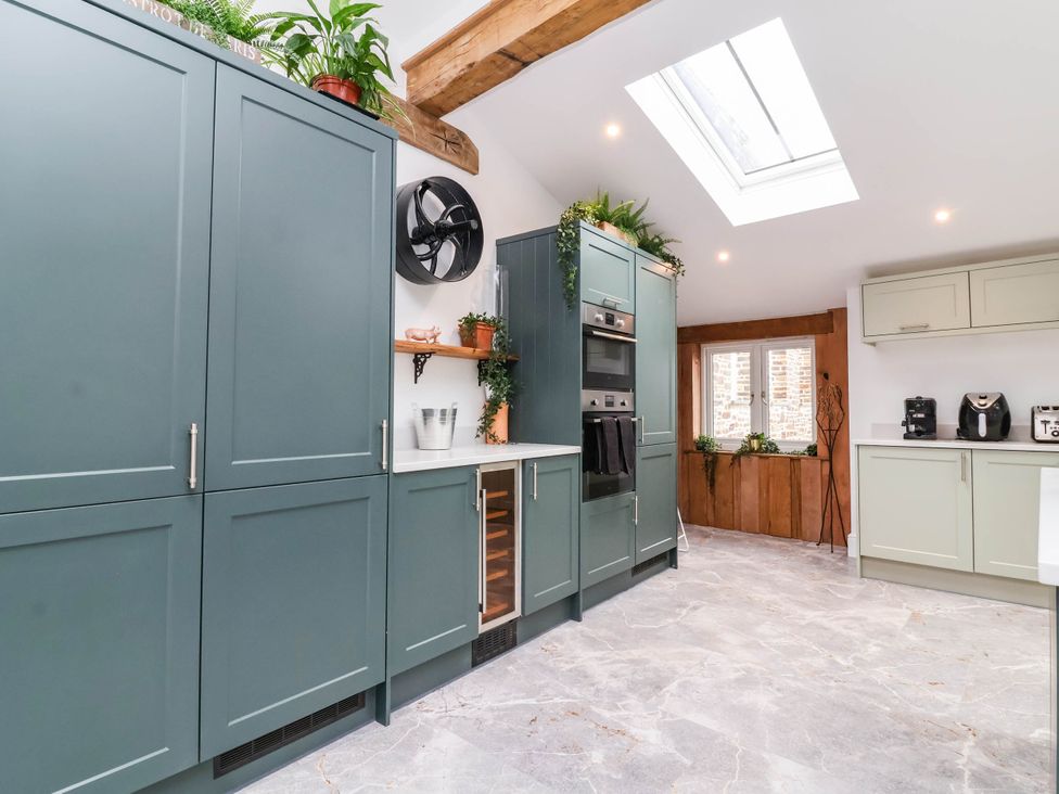 A kitchen with cabinets and appliances at The Granary in Barnstaple
