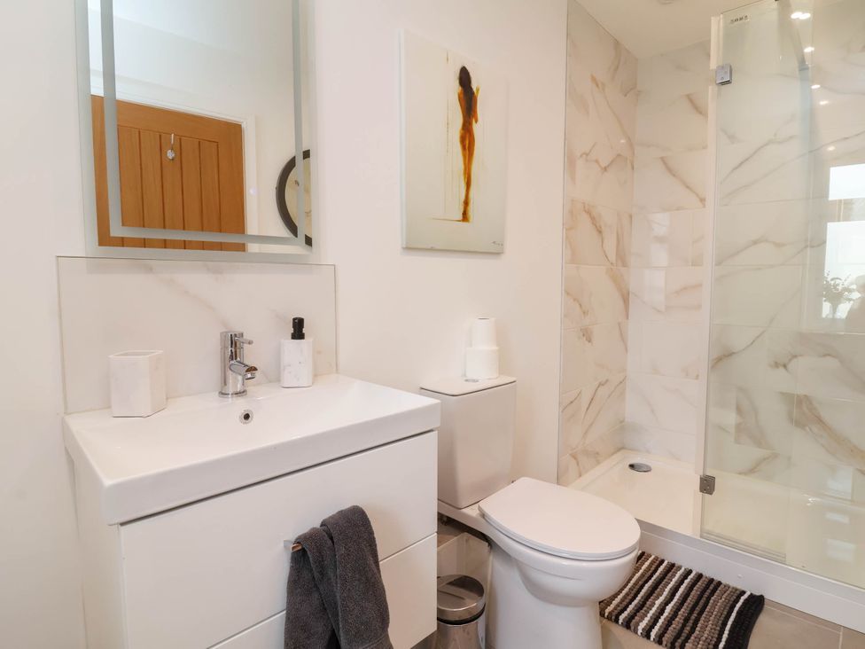 A bathroom with a sink and shower at The Granary in Barnstaple