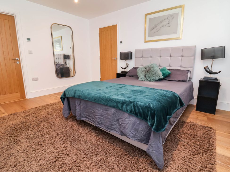 A bedroom with a bed and nightstands at The Granary in Barnstaple