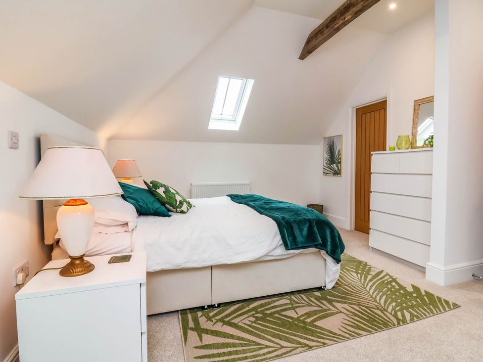 A bedroom with a bed and bedside table at The Granary in Barnstaple
