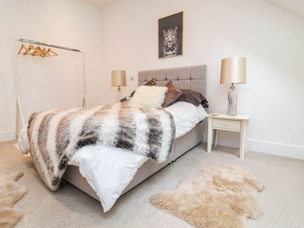 A bedroom with a bed and bedside table at The Granary in Barnstaple