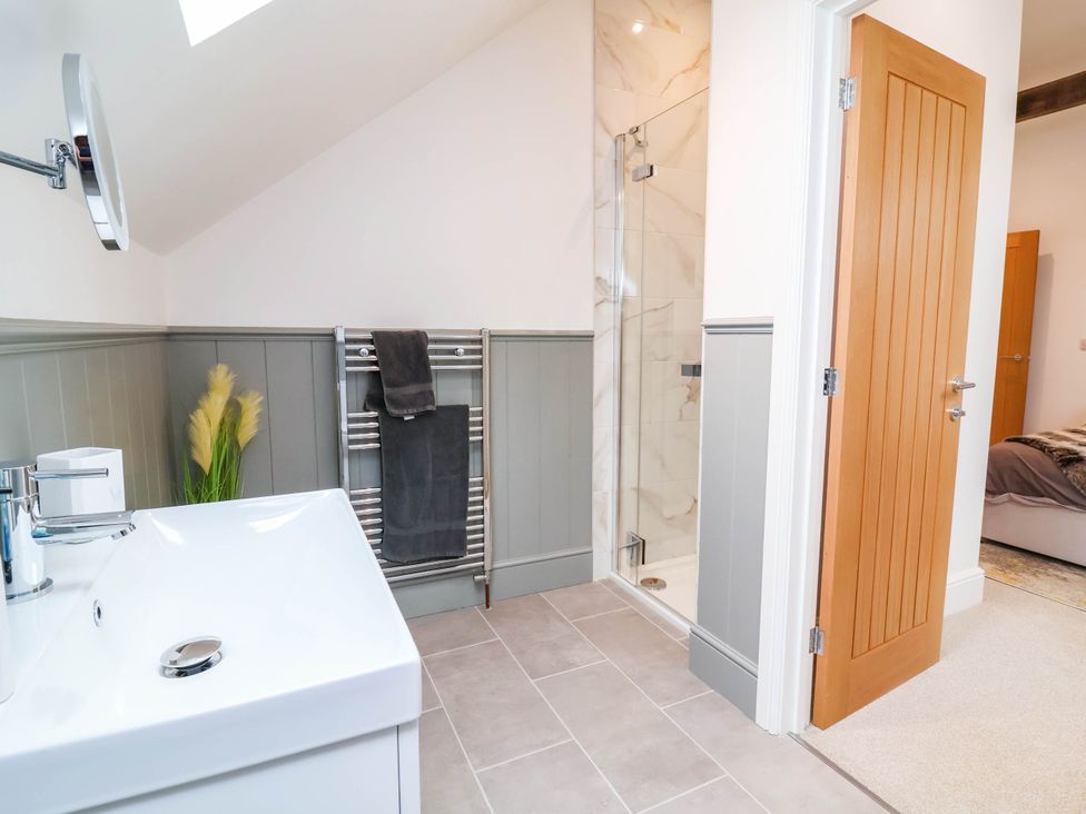 A bathroom with a sink and shower at The Granary in Barnstaple