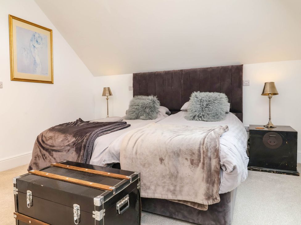 A bedroom with a bed and a trunk at The Granary in Barnstaple