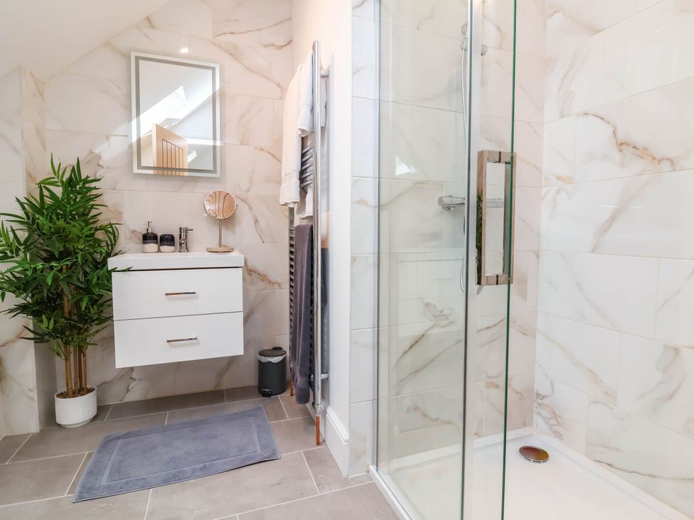 A bathroom with a shower and vanity unit at The Granary in Barnstaple